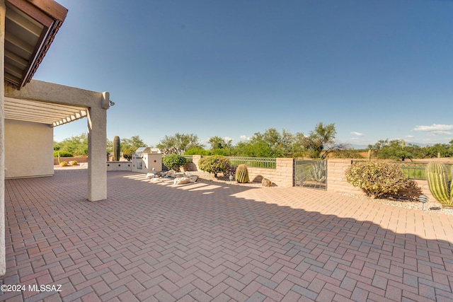 view of patio featuring fence and a gate