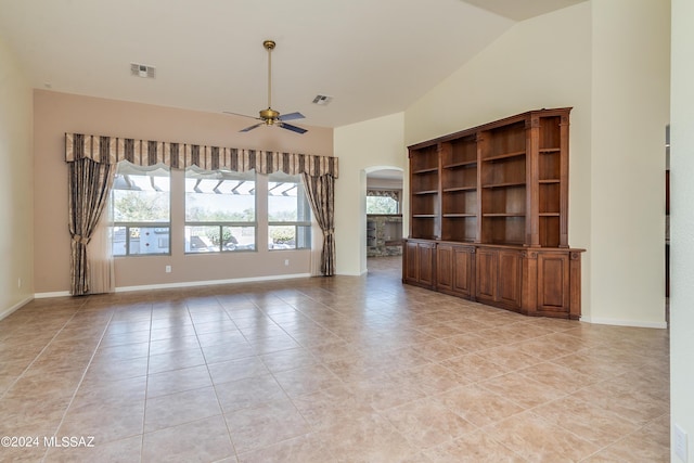 unfurnished living room featuring a ceiling fan, arched walkways, visible vents, and high vaulted ceiling