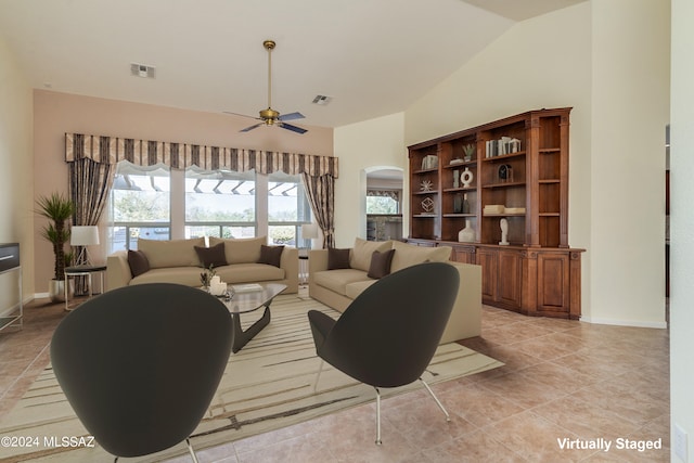 living area with visible vents, ceiling fan, and light tile patterned floors