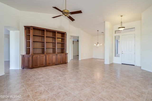 unfurnished living room with high vaulted ceiling, baseboards, arched walkways, and a ceiling fan