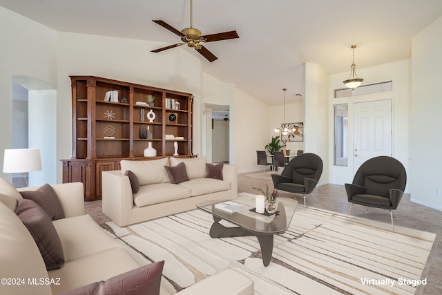 living room featuring high vaulted ceiling, baseboards, arched walkways, and ceiling fan with notable chandelier