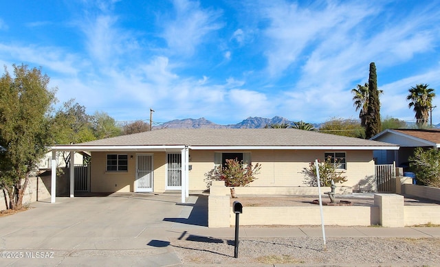 view of front facade featuring a mountain view and a carport