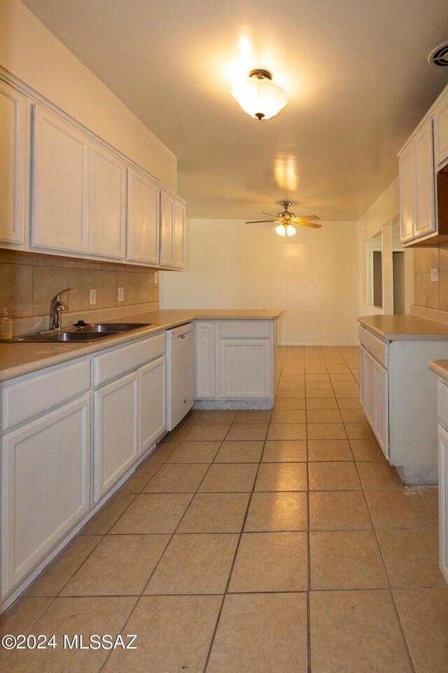 kitchen featuring white cabinetry, dishwasher, sink, and kitchen peninsula