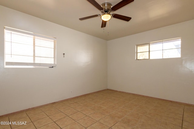 empty room featuring a healthy amount of sunlight and ceiling fan