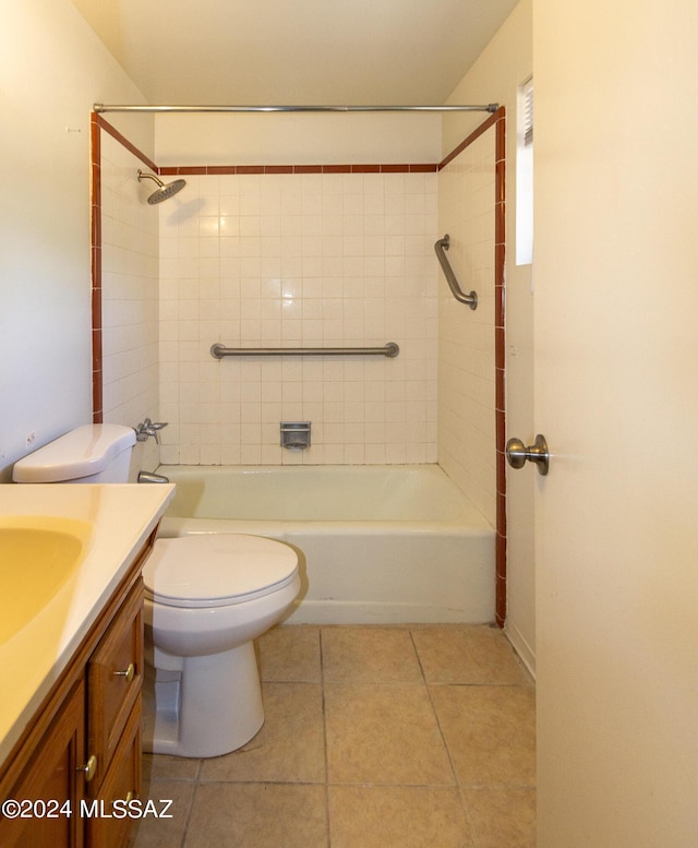 full bathroom featuring vanity, tiled shower / bath, tile patterned floors, and toilet