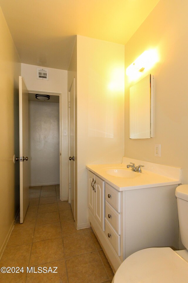 bathroom featuring vanity, toilet, and tile patterned flooring