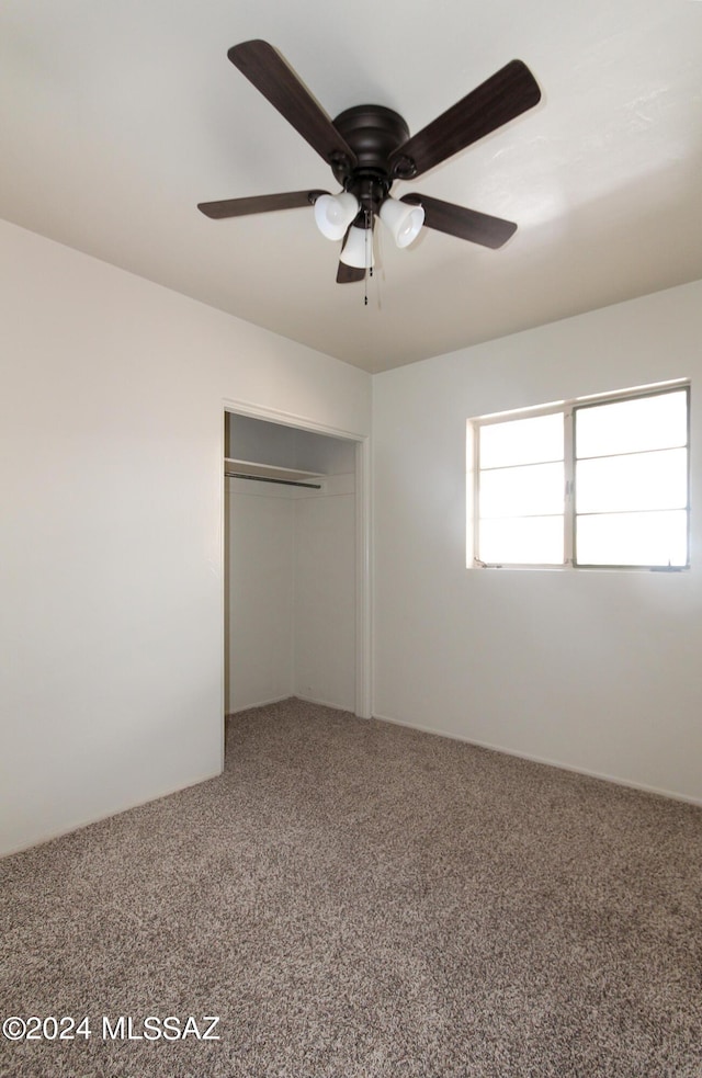 unfurnished bedroom featuring a closet, ceiling fan, and carpet flooring