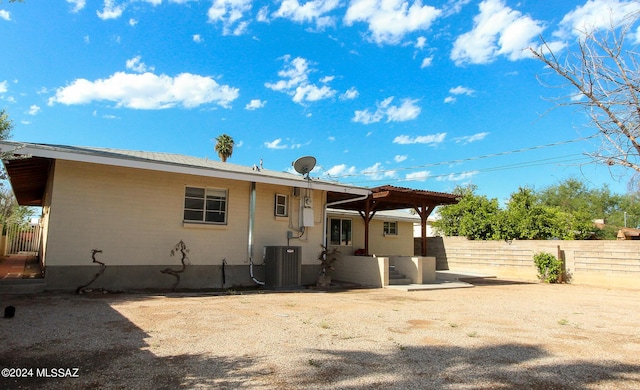 rear view of house with central AC