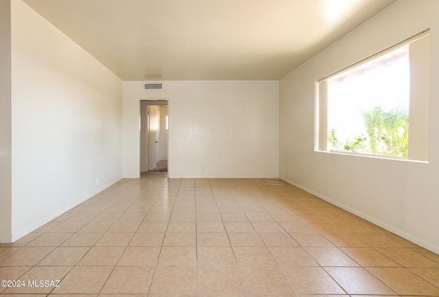 empty room with light tile patterned floors