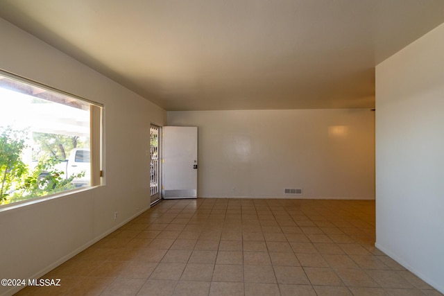 unfurnished room with light tile patterned floors