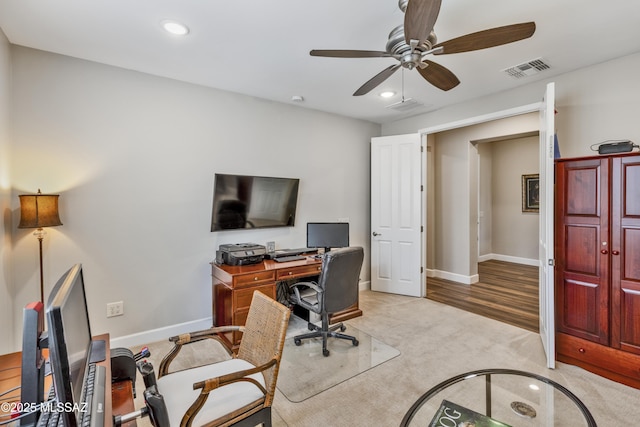 office area with light carpet and ceiling fan