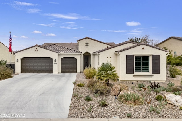 mediterranean / spanish-style home with a garage