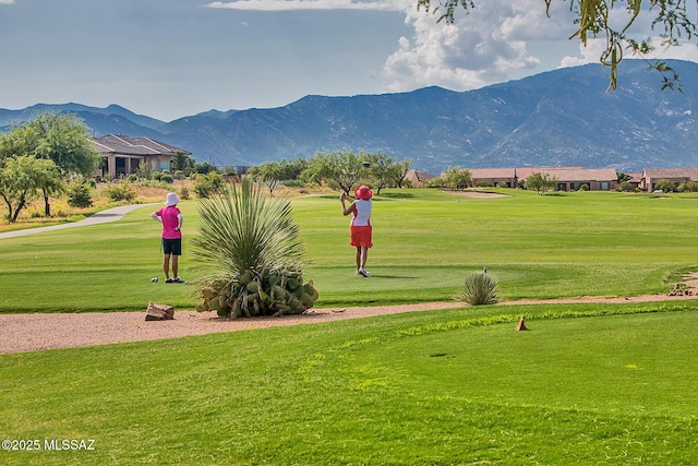 view of property's community with a lawn and a mountain view