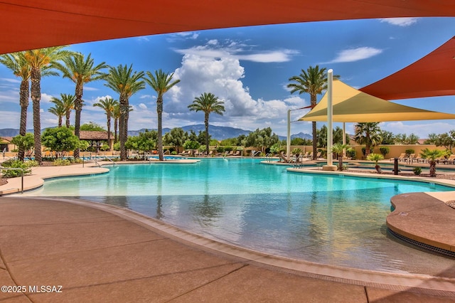 view of swimming pool with a mountain view and a patio