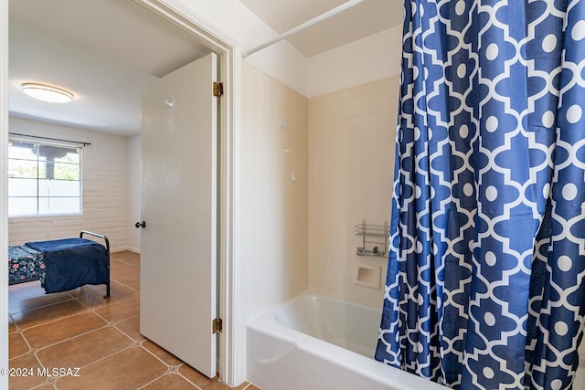 bathroom featuring shower / bath combo with shower curtain and tile patterned floors