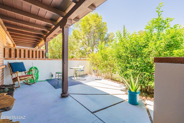 view of patio with outdoor dining area and a fenced backyard