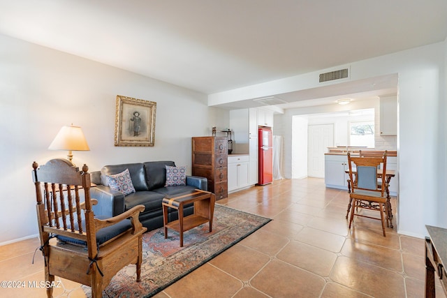 living room with light tile patterned floors and visible vents