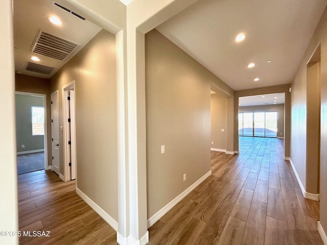 corridor with recessed lighting, wood finished floors, visible vents, and baseboards