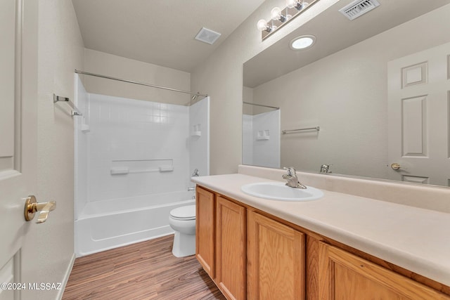 full bathroom featuring toilet, hardwood / wood-style flooring, shower / washtub combination, and vanity