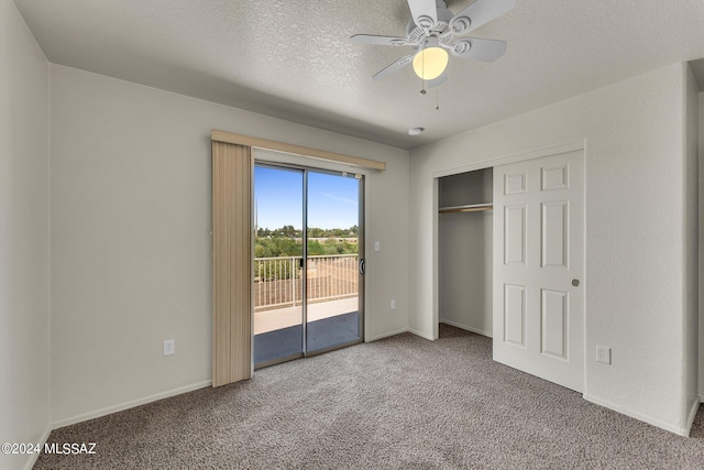 unfurnished bedroom featuring carpet, a closet, access to outside, a textured ceiling, and ceiling fan