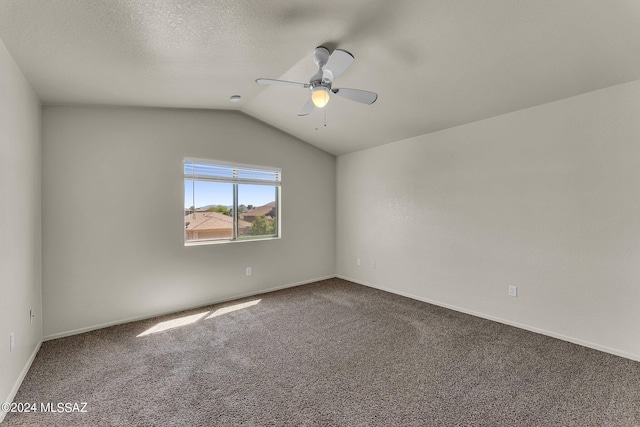 unfurnished room with ceiling fan, carpet floors, lofted ceiling, and a textured ceiling