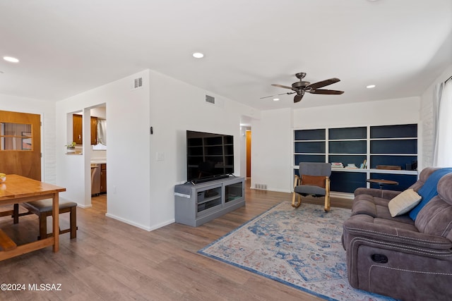 living room featuring ceiling fan and light hardwood / wood-style floors