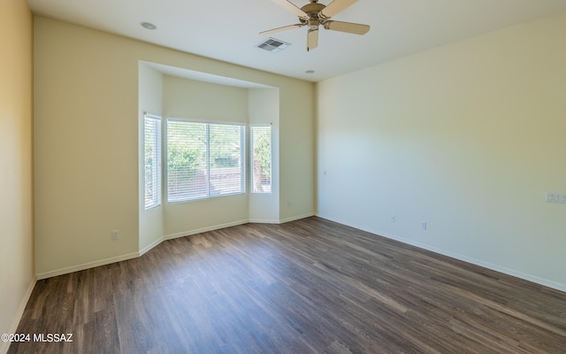 spare room with ceiling fan and dark wood-type flooring