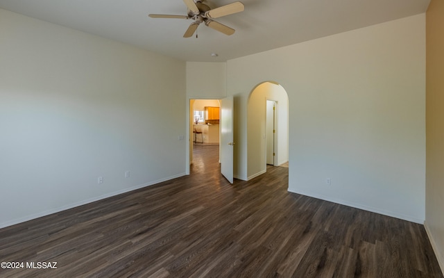 spare room with ceiling fan and dark hardwood / wood-style flooring