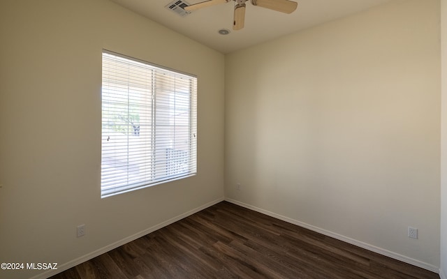 spare room with dark hardwood / wood-style flooring and ceiling fan