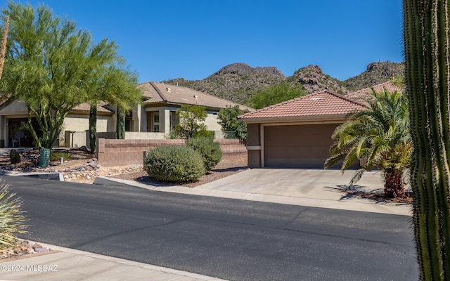 view of front facade featuring a mountain view and a garage