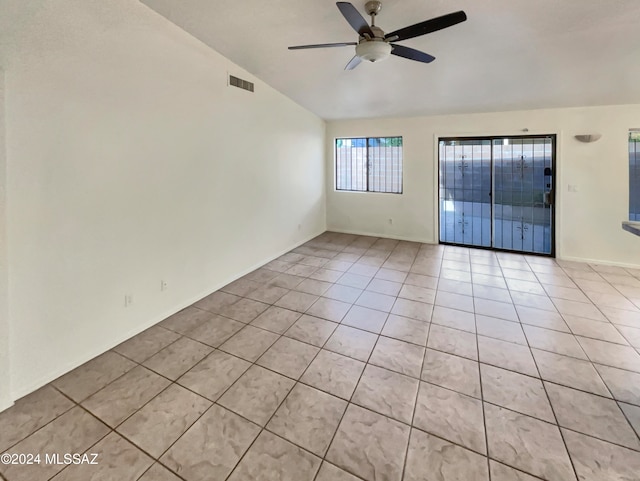 tiled spare room with ceiling fan and lofted ceiling