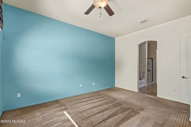 carpeted spare room with ceiling fan