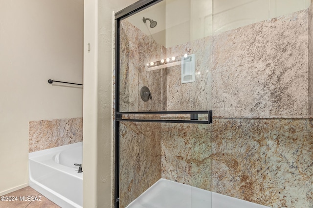 bathroom featuring tile patterned flooring and plus walk in shower