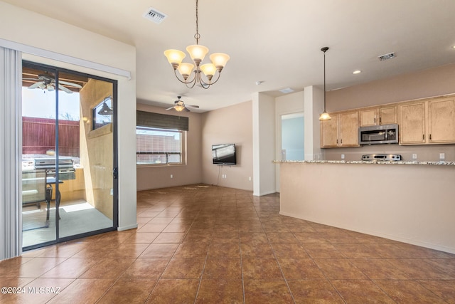 kitchen with ceiling fan with notable chandelier, pendant lighting, tile patterned floors, and light brown cabinetry