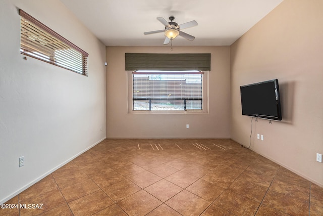 spare room featuring ceiling fan and tile patterned flooring