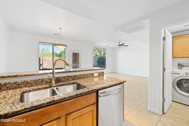 kitchen with ceiling fan, sink, dishwasher, washer / dryer, and dark stone counters