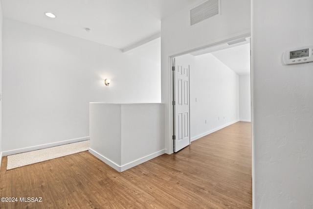 hall with hardwood / wood-style floors