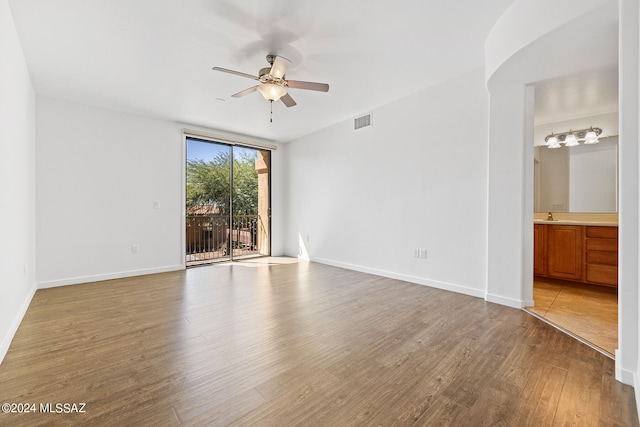 unfurnished room with ceiling fan, light hardwood / wood-style flooring, and sink