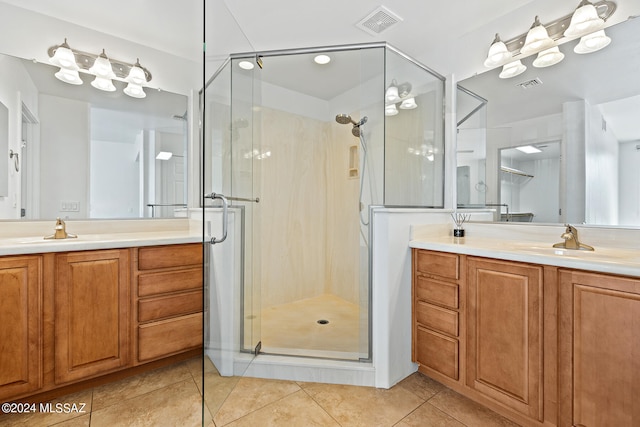 bathroom featuring vanity, a shower with shower door, and tile patterned flooring