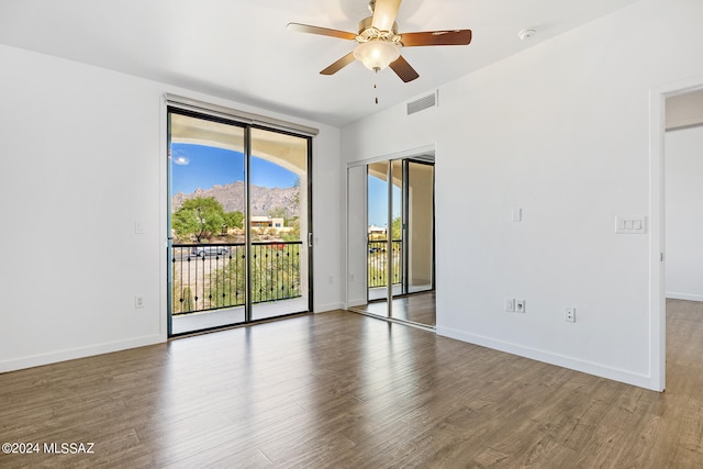 spare room featuring ceiling fan and hardwood / wood-style floors