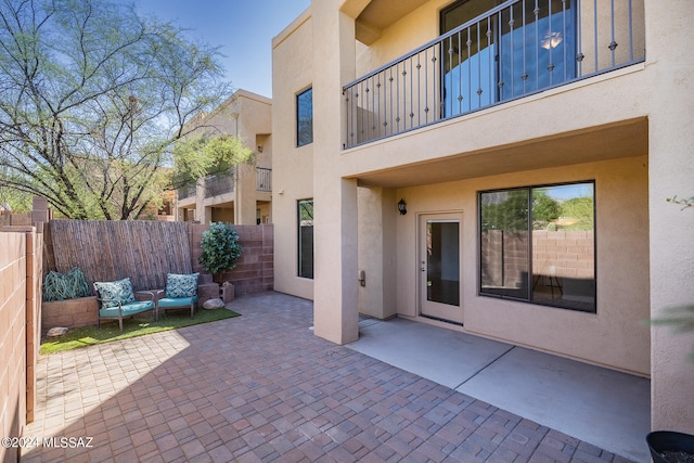 view of patio featuring a balcony