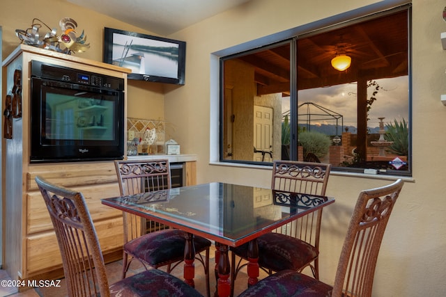 dining room with beverage cooler and vaulted ceiling