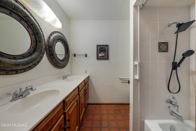 bathroom featuring tiled shower / bath, vanity, and tile patterned floors