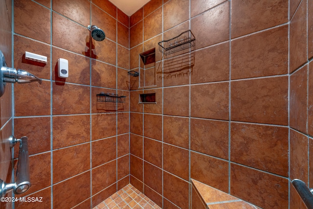 bathroom with a tile shower