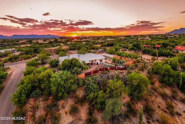 aerial view at dusk featuring a mountain view