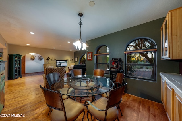 dining area featuring a notable chandelier and light wood-type flooring