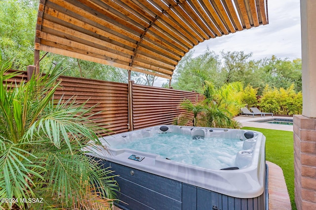 view of patio featuring an outdoor pool and an outdoor hot tub