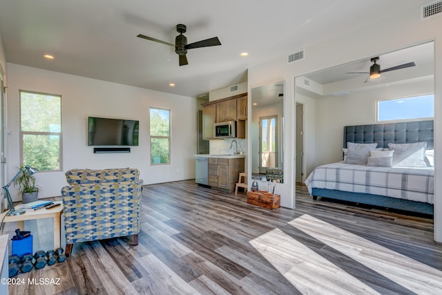 bedroom with ceiling fan and dark hardwood / wood-style flooring