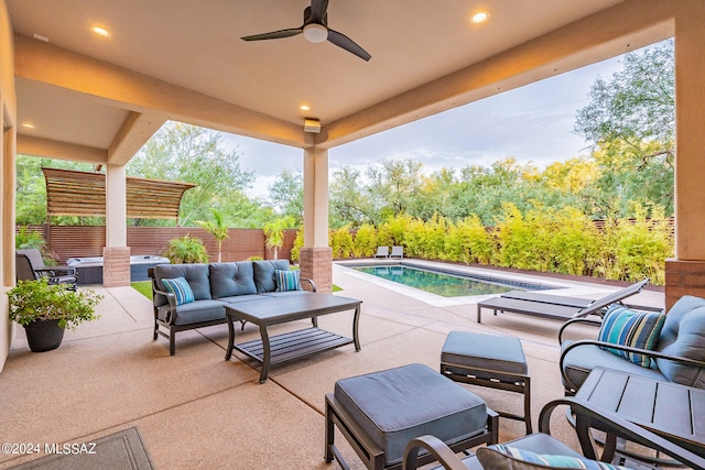 view of patio / terrace with a fenced in pool, ceiling fan, and outdoor lounge area