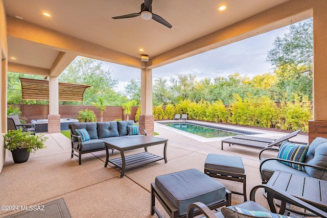 view of patio / terrace with a ceiling fan, fence, outdoor lounge area, and a fenced in pool